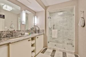 a bathroom with a shower and two sinks and a glass shower stall at Stylish 1 BR at Fort Lauderdale in Fort Lauderdale