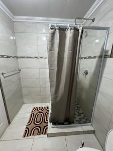 a shower with a shower curtain in a bathroom at The Ripanga Nest in Nelspruit +6 photos