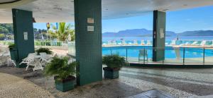 a building with a pool and a view of the water at Angra inn - Angra dos Reis - apê120 in Angra dos Reis