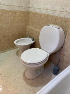 a bathroom with a white toilet and a bidet at Kairos in Buenos Aires +5 photos
