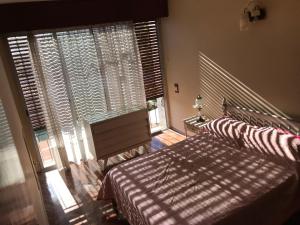 a bedroom with two beds and a large window at Large 2 floors in Carrasco in Montevideo