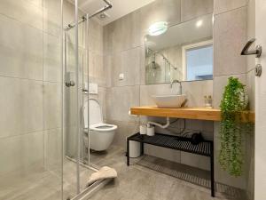 a bathroom with a shower and a sink and a toilet at TH0 Luxury two bedrooms Apartments with High-Tech Amenities in Athens +94 photos