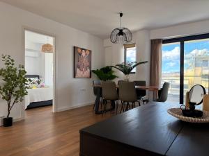 a living room with a table and chairs and a bedroom at TH0 Luxury two bedrooms Apartments with High-Tech Amenities in Athens