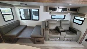 an interior of an rv with benches and windows at Luxury Rocky Mountain Glamping in Golden Canada Family Friendly AC Campfire Northern Lights Stargazing in Golden