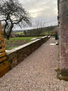 a stone retaining wall with a stone walkway at South View Cottage in Penrith