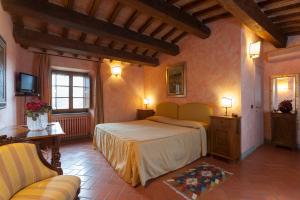 Postel nebo postele na pokoji v ubytování Relais Poggio Borgoni