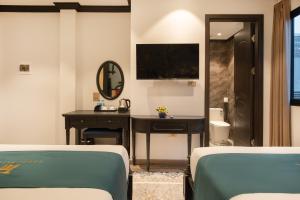Postel nebo postele na pokoji v ubytování Hanoi Bliss Hotel