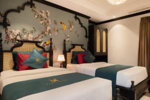 Postel nebo postele na pokoji v ubytování Hanoi Bliss Hotel