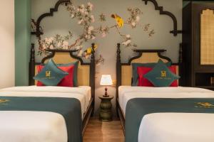 Postel nebo postele na pokoji v ubytování Hanoi Bliss Hotel