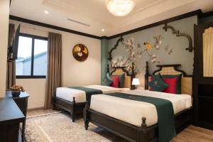 Postel nebo postele na pokoji v ubytování Hanoi Bliss Hotel