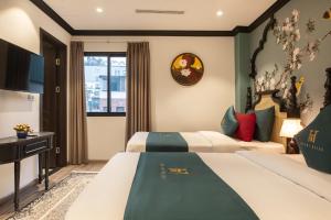 Postel nebo postele na pokoji v ubytování Hanoi Bliss Hotel