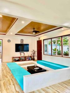 a living room with a couch and a tv at Exclusive House Pool in Panglaoo in Panglao