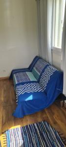 a bed sitting on the floor next to a window at Bungalow B1 in Kumak