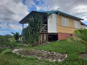 a house on a hill with a green yard at Bungalow B1 in Kumak