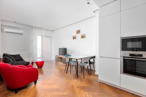 a living room with a red chair and a table at Aparthotel Hilton Blox in Tbilisi City