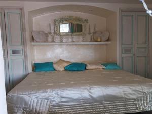 a bed with blue pillows in a bedroom at Village House in France with Private Pool in Bagnols-en-Forêt +32 photos