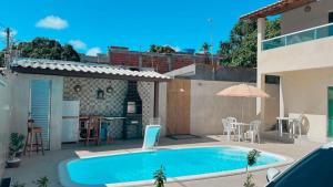 a swimming pool in the backyard of a house at Casa do Pepe em Barra de Jacuípe in Camaçari