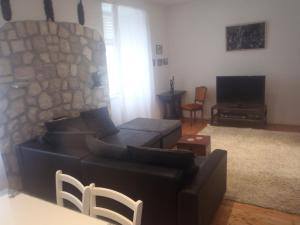 a living room with a couch and a tv at Old Town Vintage Apartment in Dubrovnik