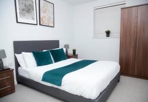 マンチェスターにあるLuxury 2 Bedroom and bathroom in Central Manchester With Balconyのベッドルーム1室(大型ベッド1台、青と緑の枕付)