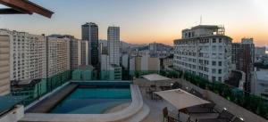 a swimming pool on the roof of a building at Flat Casa Mauá in Rio de Janeiro