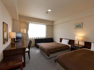 Postel nebo postele na pokoji v ubytování Komoro Grand Castle Hotel