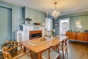a dining room with a table and a fireplace at Historic Poughkeepsie Home Near Arlington & Vassar in Poughkeepsie
