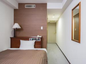 Postel nebo postele na pokoji v ubytování Komoro Grand Castle Hotel