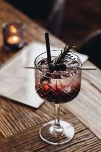 a drink sitting on a table with a garnishment at Genusshotel Vermala Montafon in Sankt Gallenkirch +125 photos