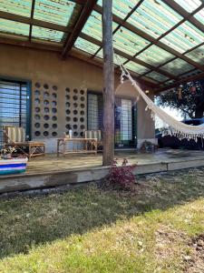 a porch of a house with a hammock at Casa de Mar y Barro in Maldonado