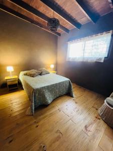 a bedroom with a bed in a room with a window at Casa de Mar y Barro in Maldonado
