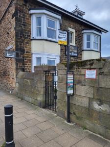 a street sign in front of a brick building at Station Guesthouse - Self entry via keypad inc parking in Lancaster