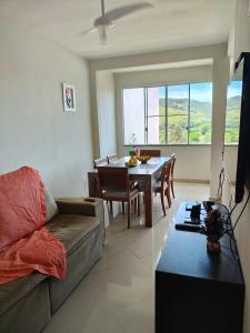 a living room with a couch and a table at Tarituba Ilha in Paraty