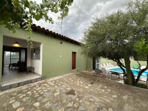 a house with a patio and a swimming pool at EL PEDREGAL cabaña rural de 1 domitorio hasta 4 personas in Cafayate
