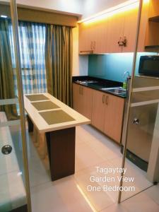 a kitchen with a sink and a counter top at Tagaytay Cozy 1BR Wind Residences in Kaybagal