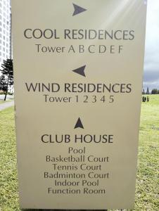 a sign for a wind resilience tower a abject at Tagaytay Cozy 1BR Wind Residences in Kaybagal +13 photos
