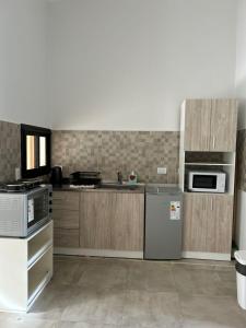 a kitchen with a sink and a stove top oven at Cerros de Cafayate, Casa Nº2 in Cafayate