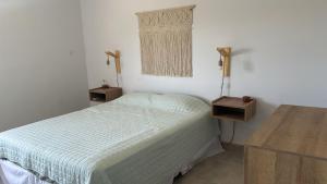 a small bedroom with a bed and a table at Cerros de Cafayate, Casa Nº2 in Cafayate
