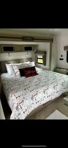 a bedroom with a large bed with a comforter on it at Luxury Rocky Mountain Glamping in Golden Canada Family Friendly AC Campfire Northern Lights Stargazing in Golden
