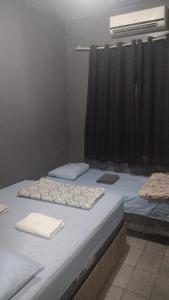 Cama ou camas em um quarto em Hostel da Floresta
