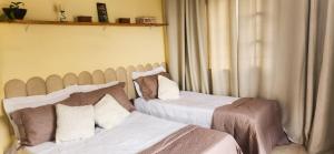 a bedroom with two beds and a window at Casa Chico Rei in Ouro Preto