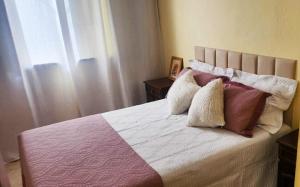 a bedroom with a bed with pillows and a window at Casa Chico Rei in Ouro Preto +17 photos