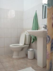 a bathroom with a toilet and a sink at Apartamentos t2 centro in Tarrafal