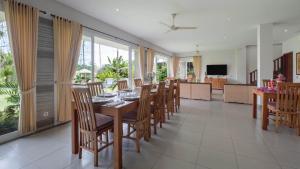 a dining room and living room with a table and chairs at Villa Yenian by Villa Finder in Canggu