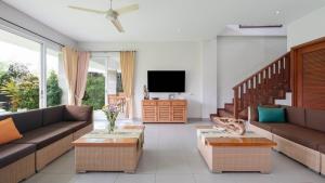 a living room with a couch and a tv at Villa Yenian by Villa Finder in Canggu +41 photos