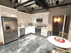 a kitchen with white cabinets and stainless steel appliances at The Secret Cenote Hotel in Jacksonville +66 photos
