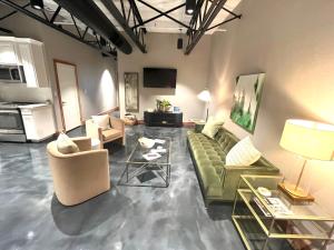 a living room with a green couch and chairs at The Secret Cenote Hotel in Jacksonville