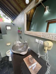a bathroom with a sink and a mirror at Apit Lawang Villas & Resto in Nusa Penida