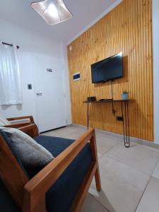 a room with a bed and a tv on a wall at Lagom Apart 1 in Posadas