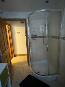 a shower in a bathroom with a glass shower stall at Peace House in Leeds
