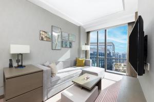 a living room with a couch and a large window at Hyatt House Shanghai Hongqiao CBD in Shanghai